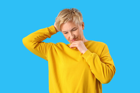 Thoughtful mature woman on blue background