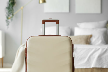 Big suitcase in light bedroom, closeupの写真素材