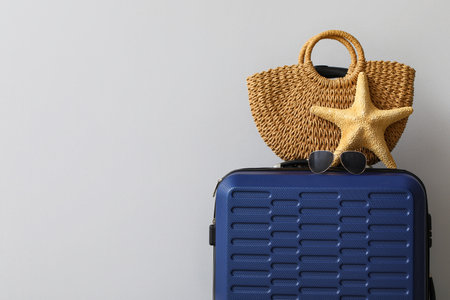 Suitcase with bag, sunglasses and starfish on gray backgroundの写真素材