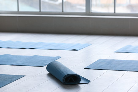 Yoga mats on floor near window in gym