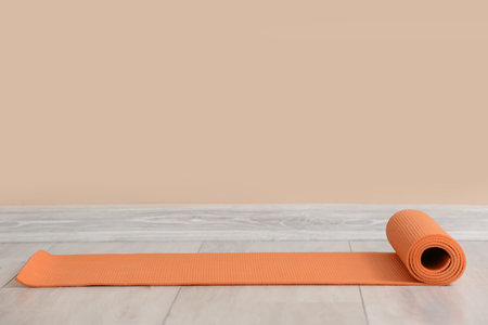 Yoga mat near beige wall in gymの写真素材