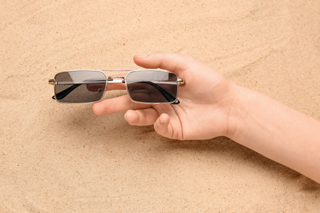Woman with sunglasses on sandの写真素材