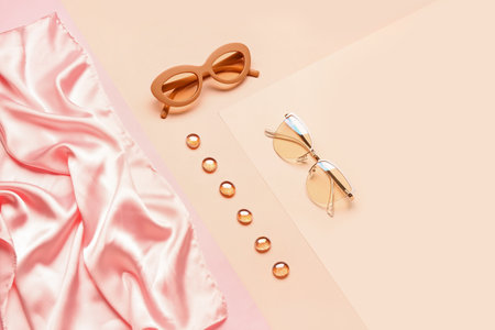 Sunglasses with glass stones and cloth on color backgroundの写真素材