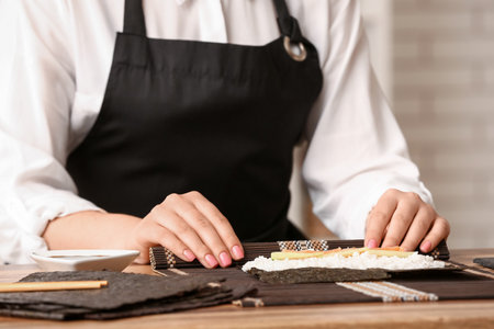 Woman preparing delicious sushi rolls, closeupの写真素材
