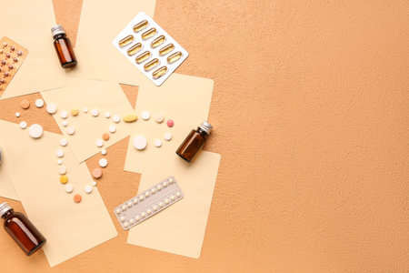 Uterus made of pills, medications and paper sheets on beige backgroundの写真素材