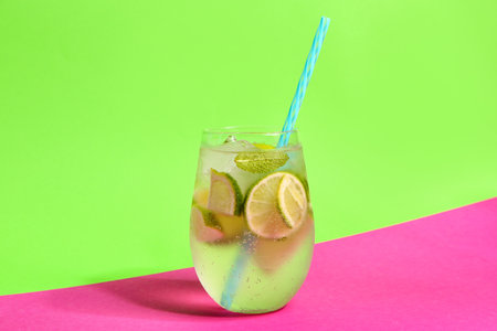 Glass of cold mojito on colorful backgroundの写真素材