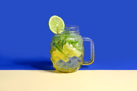 Mason jar of cold mojito on colorful backgroundの写真素材
