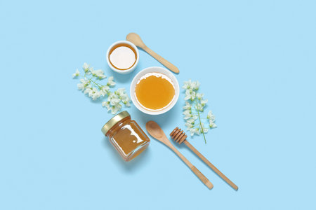 Composition with sweet honey and acacia flowers on blue backgroundの写真素材