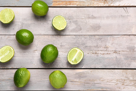 fresh limes on gray wooden background