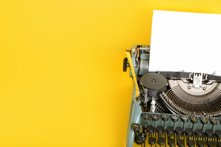 vintage typewriter on yellow backgroundの写真素材