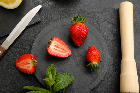 Ripe strawberry and mint on dark background, closeupの写真素材