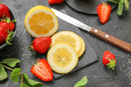 Ripe strawberry, lemon slices and mint on dark background, closeupの写真素材
