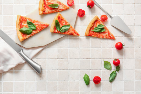 Board with tasty pizza margarita on white tile backgroundの写真素材