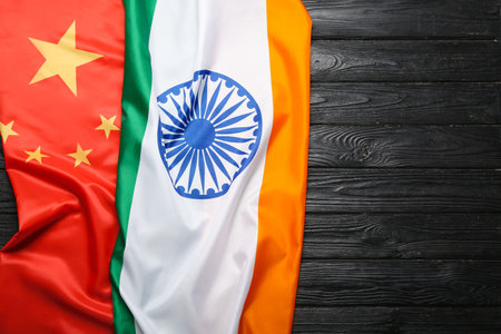 Flags of India and China on dark wooden backgroundの写真素材