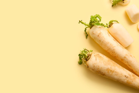 fresh daikon radish on yellow background