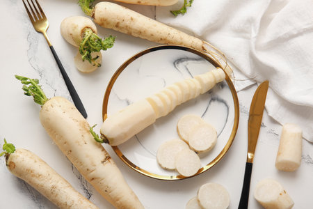 Plate with fresh daikon radish on white backgroundの写真素材