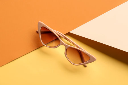 Stylish sunglasses on color backgroundの写真素材