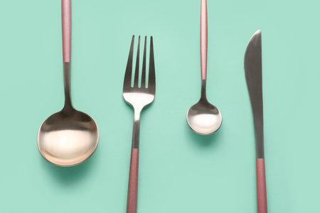Stylish cutlery on green backgroundの写真素材