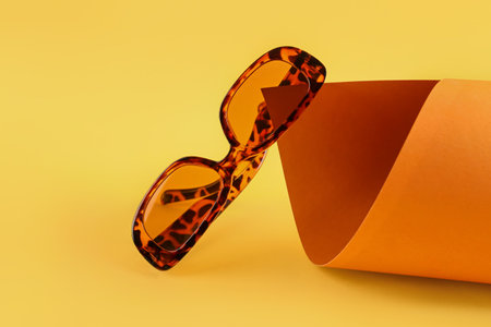 Stylish sunglasses on color backgroundの写真素材