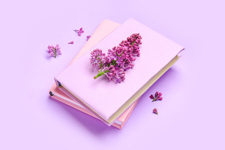 Lilac twig on notebooks on color backgroundの写真素材
