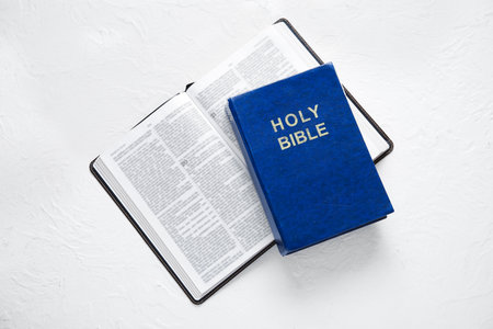 Open Holy Bible on white textured backgroundの写真素材