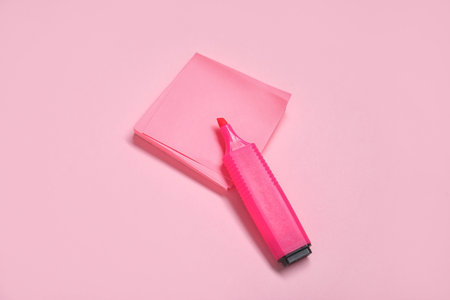 Sticky note with marker on pink background