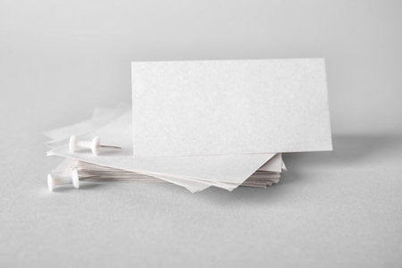 White sticky notes with pins on gray backgroundの写真素材