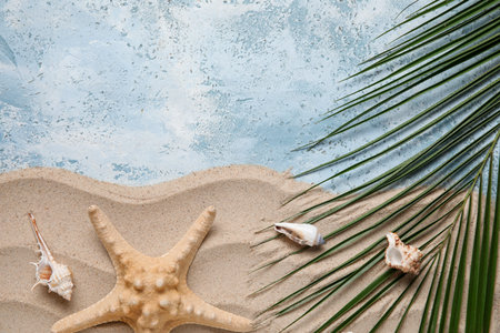 Composition with starfish, seashells, sand and palm leaf on color background, closeupの写真素材