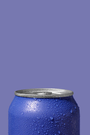 Can of fresh soda with water drops on lilac background, closeupの写真素材