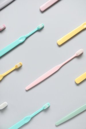 Plastic toothbrushes on gray backgroundの写真素材