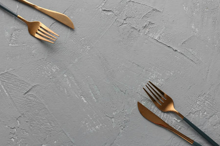 Silver forks with knives on green grunge background