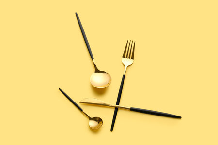 Stylish cutlery on yellow backgroundの写真素材