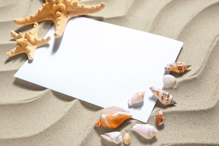 Blank card, starfishes and seashells on sandの写真素材