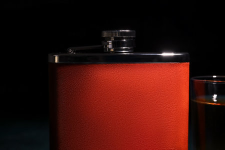 New hip flask on dark background, closeupの写真素材