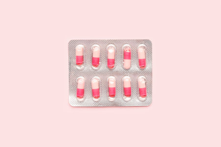 Blister of hormonal pills on pink backgroundの写真素材