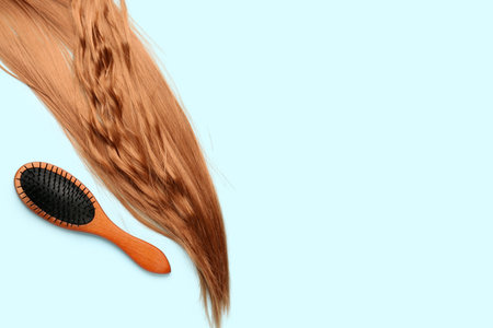 Ginger hair with brush on blue backgroundの写真素材
