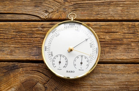 Aneroid barometer on brown wooden backgroundの写真素材