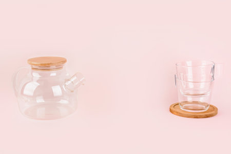 Teapot and cups on pink backgroundの写真素材