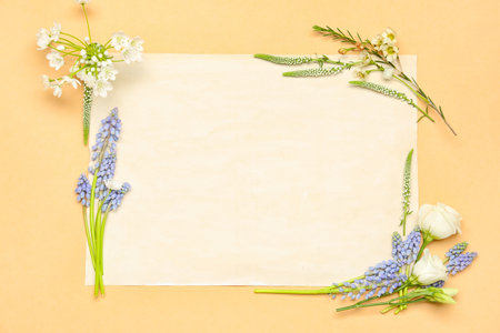 Blank greeting card with different flowers on beige backgroundの写真素材