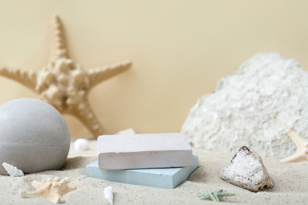 Decorative plaster podiums in sand on light backgroundの写真素材