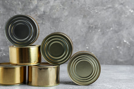 Tin cans with fish on gray grunge tableの写真素材