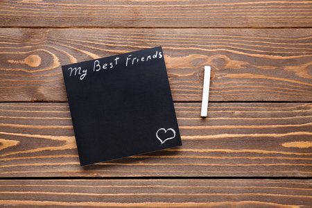 Blackboard with text MY BEST FRIENDS and chalk on wooden backgroundの写真素材