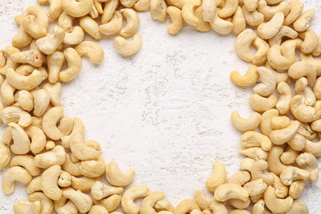 frame made of cashew nuts on light backgroundの写真素材