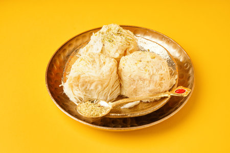 Plates with tasty Turkish Pismaniye on yellow backgroundの写真素材