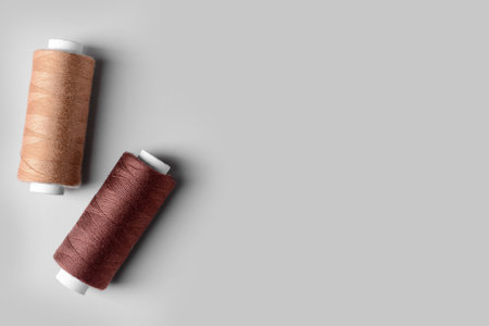 Two thread spools on color backgroundの写真素材