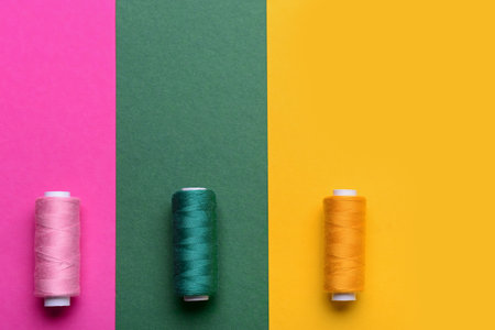 Set of thread spools on color backgroundの写真素材