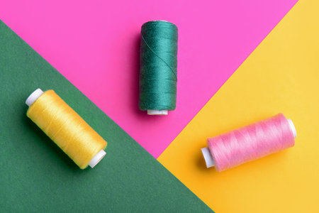 Set of thread spools on color background