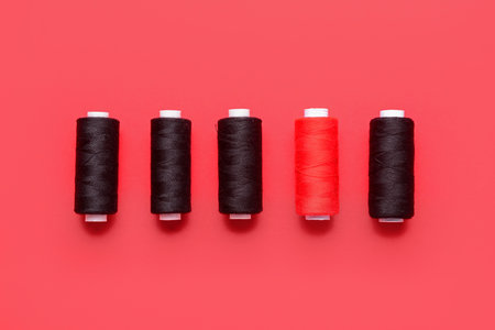 Set of thread spools on red backgroundの写真素材