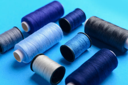 Composition with different thread spools on color background, closeupの写真素材