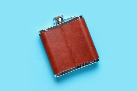 New hip flask on blue backgroundの写真素材